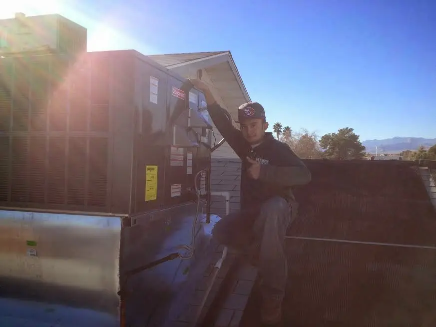 HVAC technician performing Boiler Repair on a rooftop unit in Inglewood